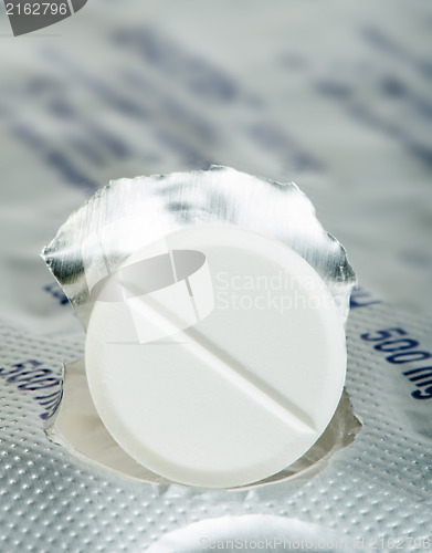 Image of White pill in a pack very close up