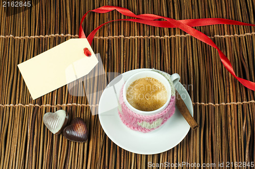 Image of Cup of coffee with knitted heart symbol