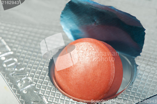 Image of Red pill in a pack very close up