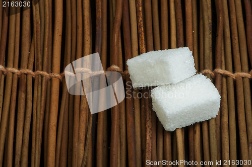 Image of Sugar lumps on wooden base