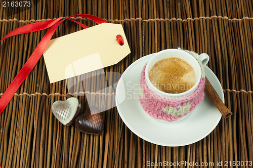 Image of Cup of coffee with knitted heart symbol