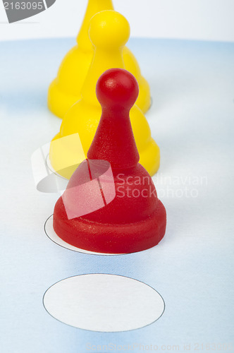 Image of Red and yellow game pawns white isolated
