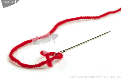 Image of Sewing needle and red thread