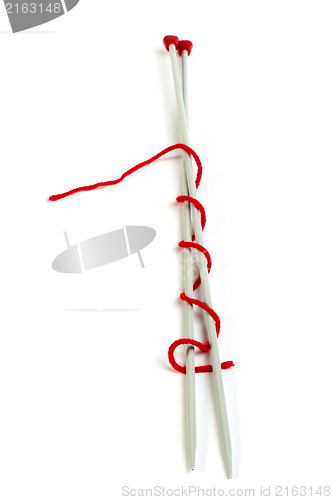 Image of Knitting skewers and red yarn