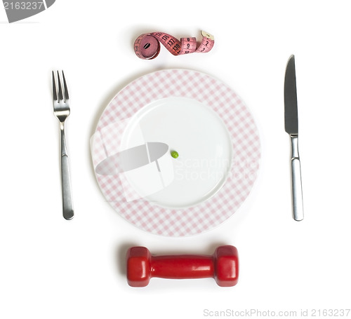 Image of Plate with one peas. Dumbbell and centimeter measure. 