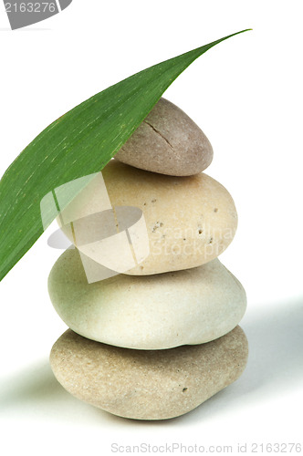 Image of Stacked stones and green leafs