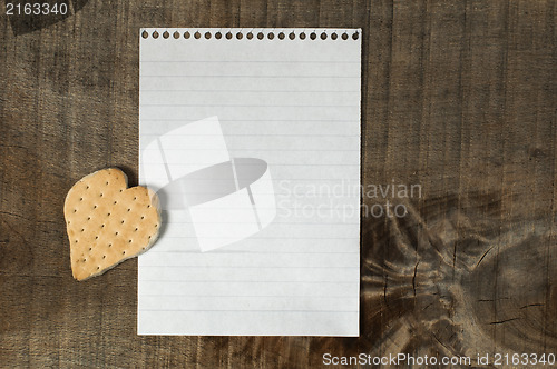 Image of Heart shape cookie on wooden background