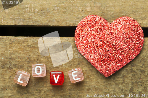 Image of Word love on multicolored wooden cubes on wooden background