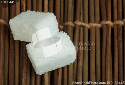 Image of Sugar lumps on wooden base