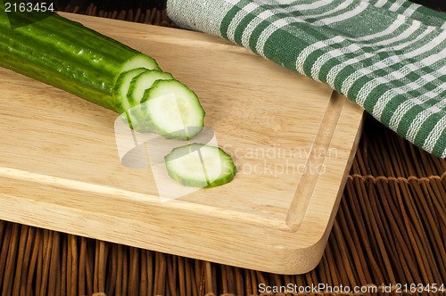 Image of Sliced ??cucumber on a wooden board