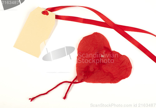 Image of Heart made ??of curled red paper and label