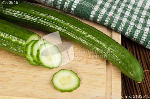 Image of Sliced ??cucumber on a wooden board