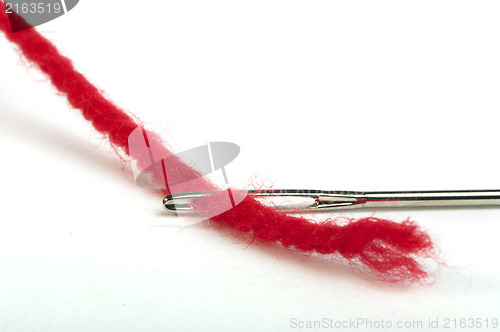 Image of Sewing needle and red thread