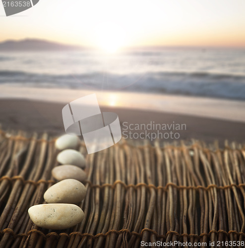 Image of Sequence of stones on wooden base for spa