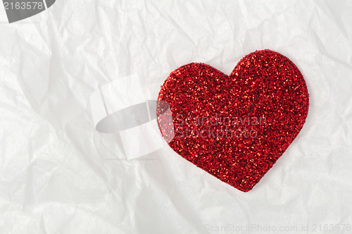 Image of Shiny red heart on white paper