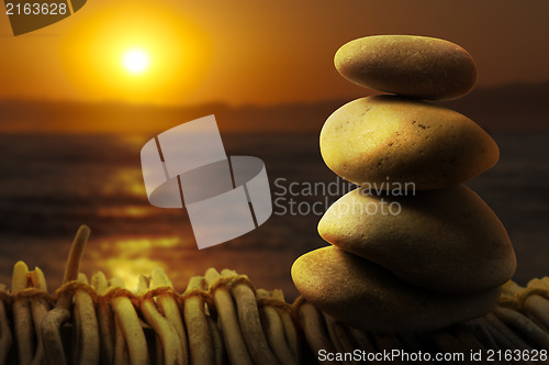 Image of Stacked stones on wooden base for spa