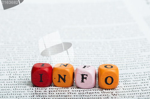 Image of Word info.Wooden cubes on magazine