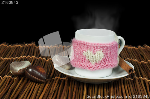 Image of Cup of coffee with knitted heart symbol