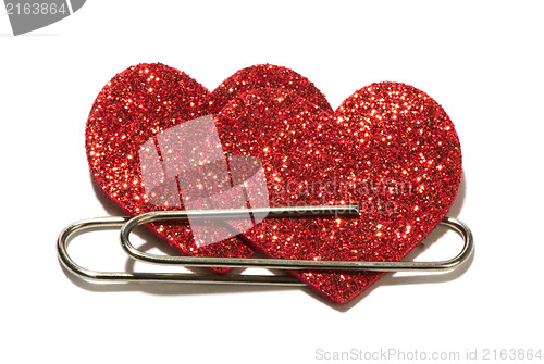 Image of Two red hearts attached with a paper clip