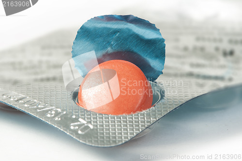 Image of Red pill in a pack very close up