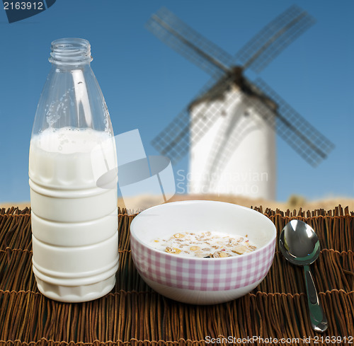 Image of Muesli breakfast in a bow, spoon and milk