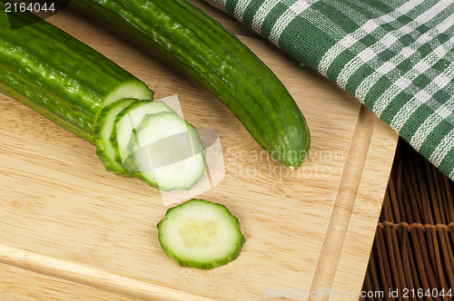 Image of Sliced ??cucumber on a wooden board