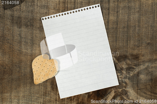 Image of Heart shape cookie on wooden background