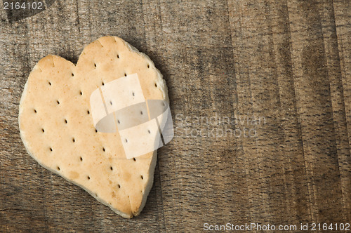 Image of Heart shape cookie on wooden background