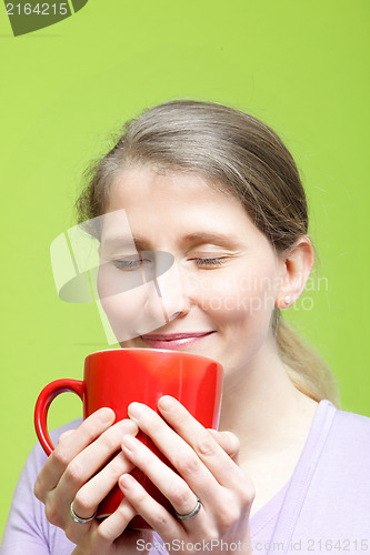 Image of Woman savouring a mug of hot coffee