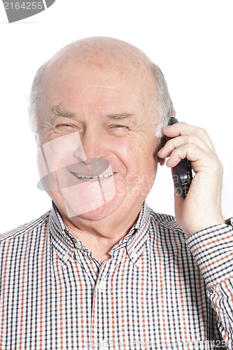 Image of Senior man laughing while talking on phone