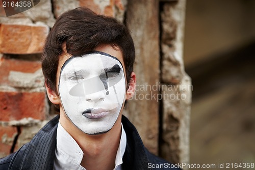 Image of Guy mime against an old brick wall.