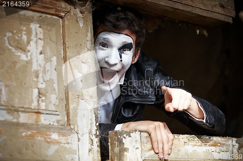 Image of Guy mime against the old wooden door.