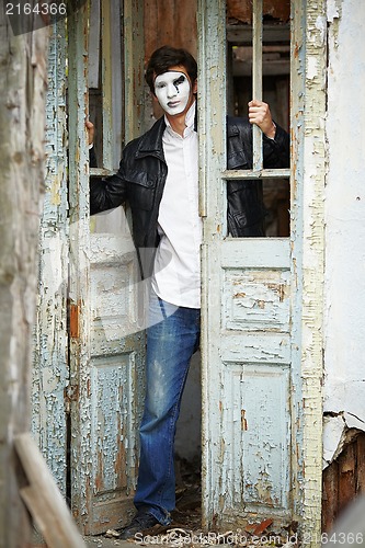 Image of Guy mime against the old wooden door.