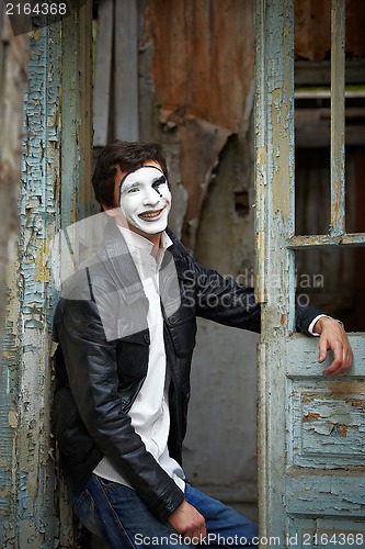 Image of Guy mime against the old wooden door.