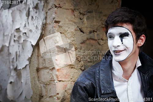 Image of Guy mime against an old brick wall.
