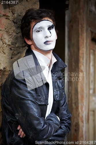 Image of Guy mime against an old brick wall.