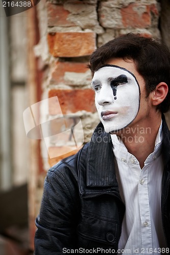 Image of Guy mime against an old brick wall.