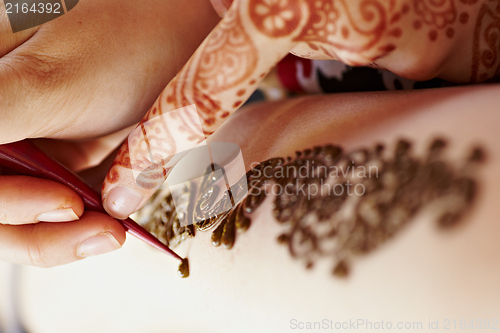 Image of Henna art on woman's hand