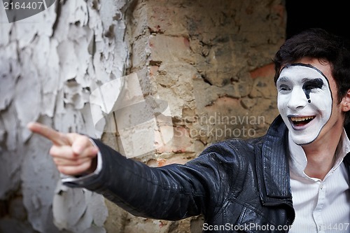 Image of Guy mime against an old brick wall.