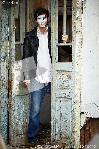 Image of Guy mime against the old wooden door.