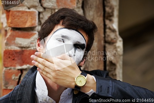 Image of Guy mime against an old brick wall.