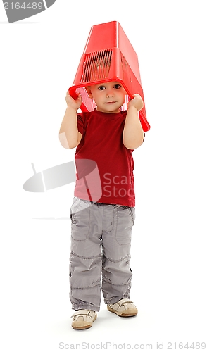 Image of Little boy pulling garbage bin on head