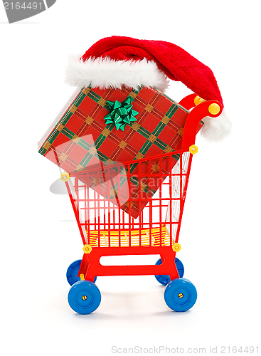 Image of Big present and Santa hat in toy shopping cart