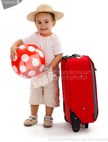 Image of Kid with red ball and suitcase, ready for journey