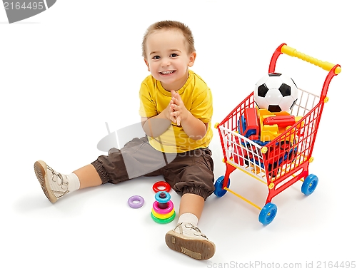 Image of Happy little boy, playing with new toys