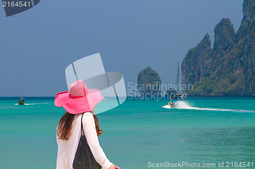 Image of Young woman walking on the beach 