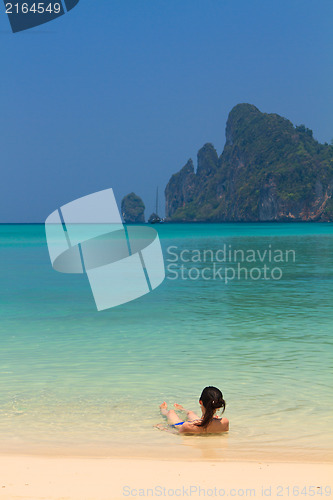 Image of Young womand relaxing at the beach