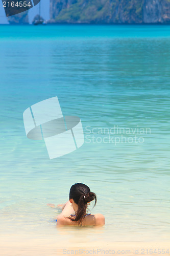 Image of Young womand relaxing at the beach