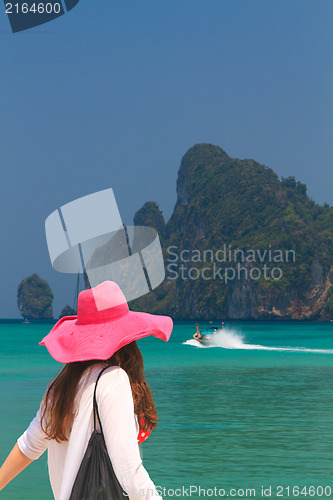 Image of Young woman walking on the beach 