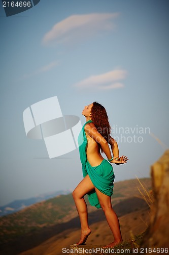 Image of Beautiful girl standing on a precipice